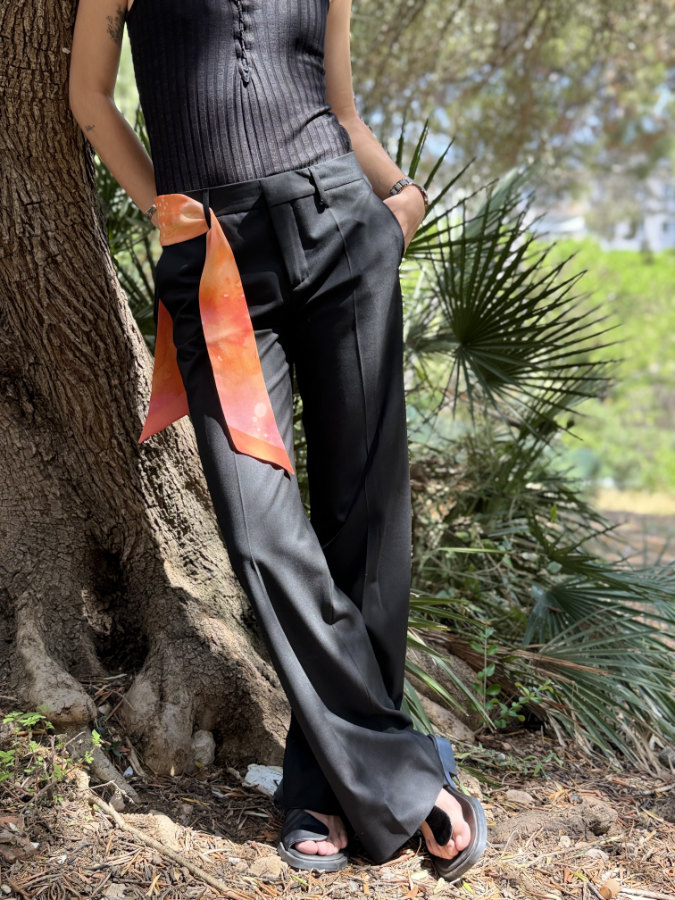 natural orange silk ribbon on the waistband of black pants