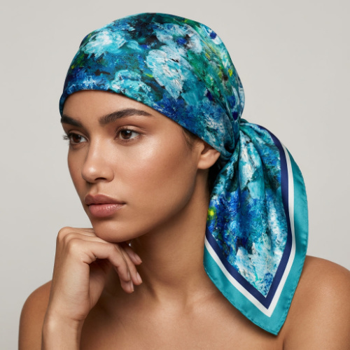Close-up of a woman with a turquoise-blue silk scarf covering her entire head, vintage style to protect hair from the sun.
